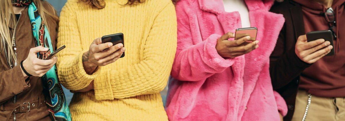 Group friends using mobile smartphones outdoor