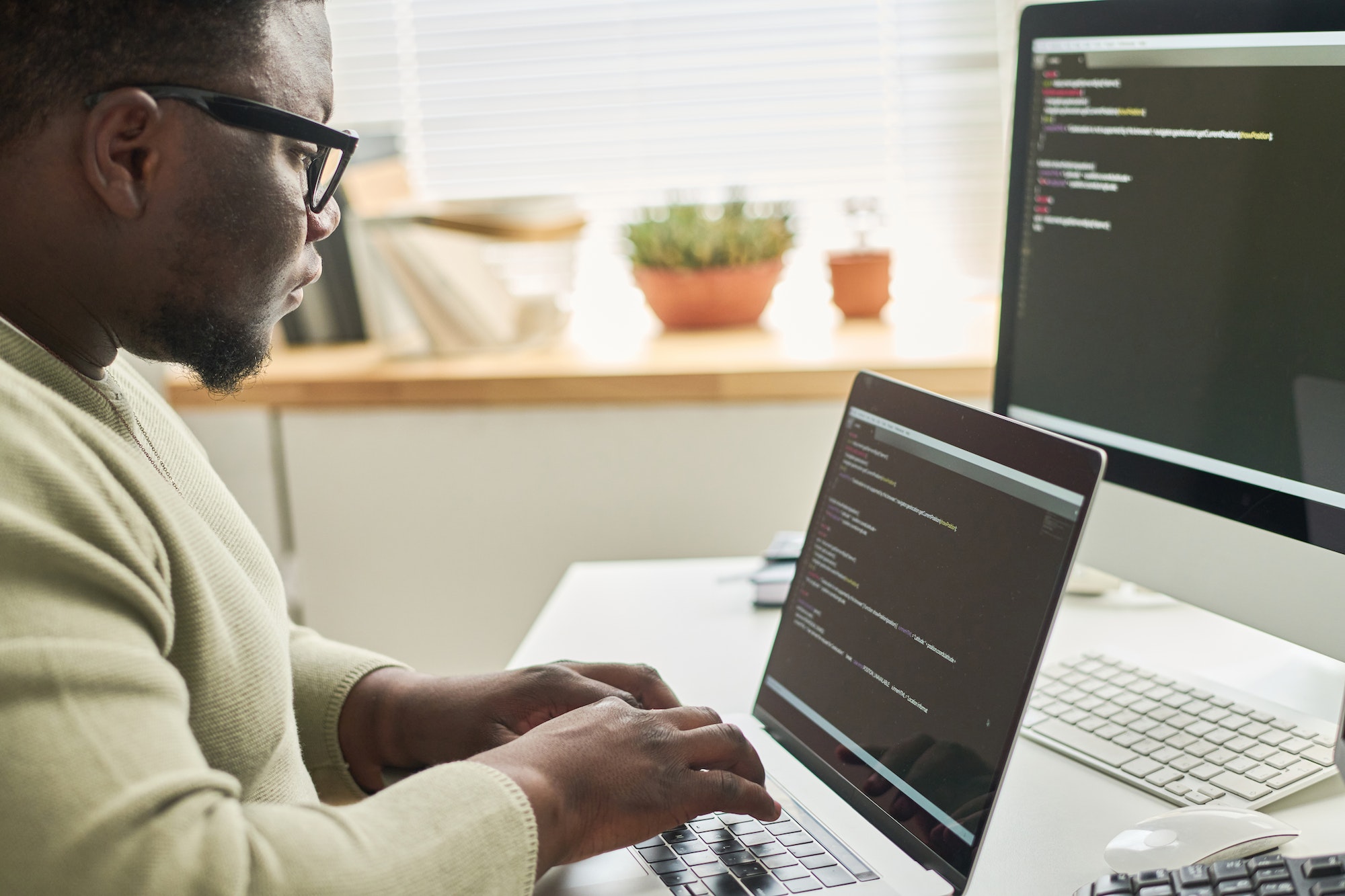 Programmer typing data code on laptop